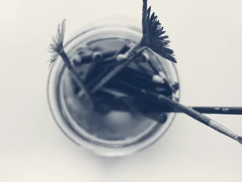 Brushes standing in a cleaning jar